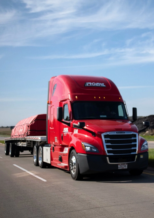 Roehl flatbed trucking company truck & trailer on the road