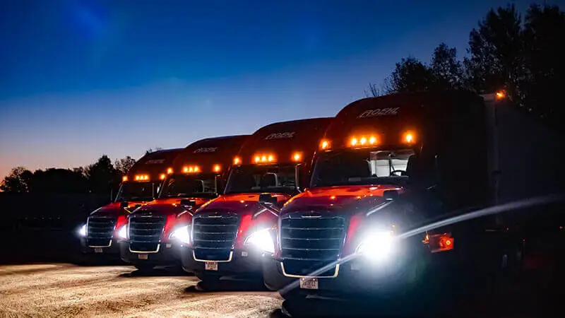 Four semi-trucks at night